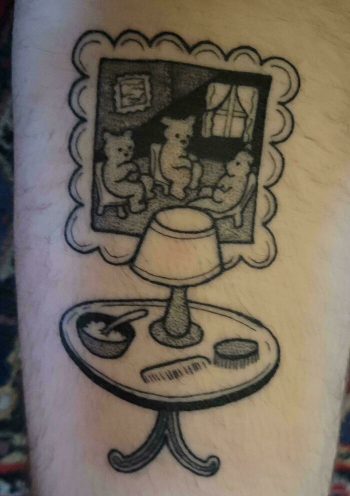 Tattoo of a vintage family scene with bears on chairs above a table, capturing a funny and wholesome dad moment.