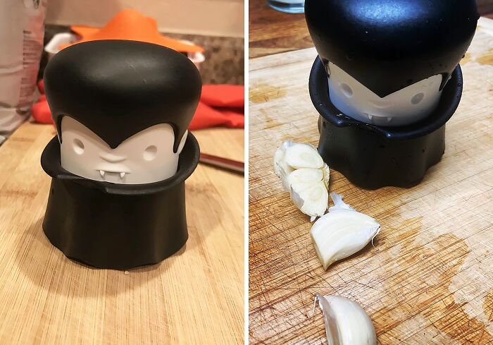 Vampire-themed garlic chopper on a wooden cutting board, showcasing one of the weirdest kitchen items.