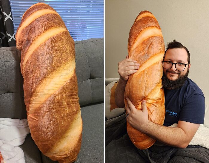 Giant bread-shaped pillow on couch and man hugging the borderline genius random thing in a cozy room.