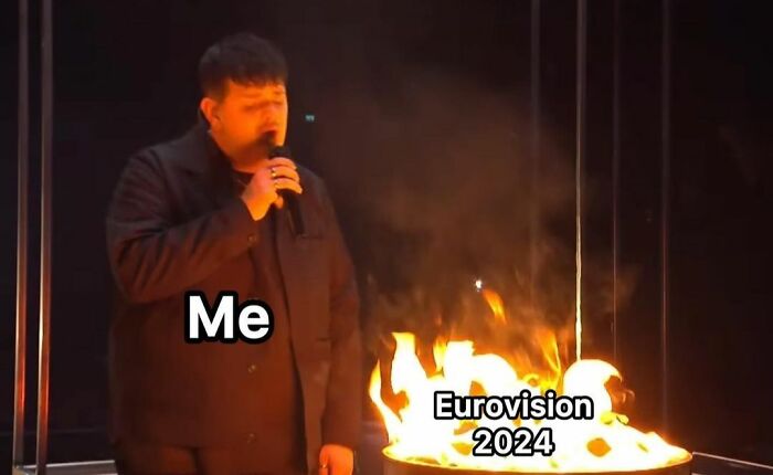 A person by a fire, holding a microphone, with text overlay "Me" and "Eurovision 2024" celebrating the Eurovision Song Contest.