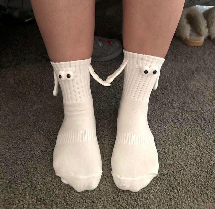 White socks with googly eyes and attached hands, a borderline genius and random creative fashion idea.