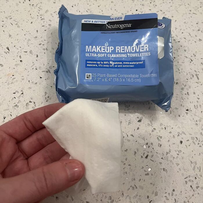 A hand holding a Neutrogena makeup remover towelette, a best seller on Amazon.