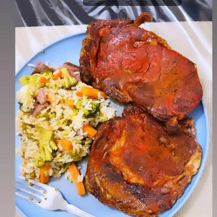 Unappetizing food photo with overcooked meat and mixed vegetables on a plate.