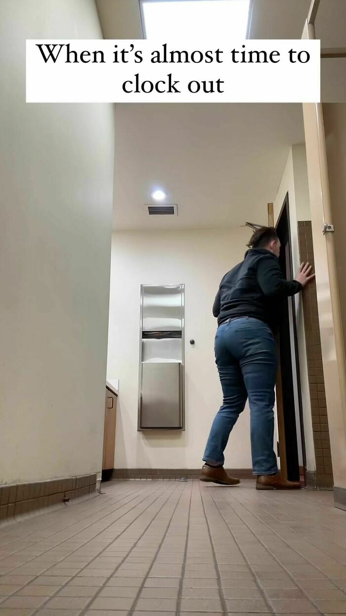 Person eagerly looking out a door at work, capturing a humorous moment related to memes.