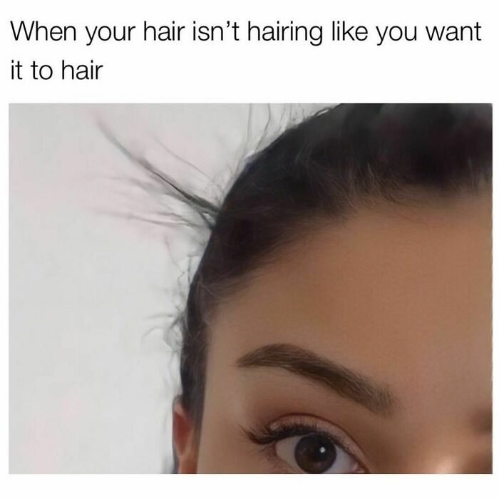 Close-up of a woman's face with messy hair, relating to memes about hair struggles.