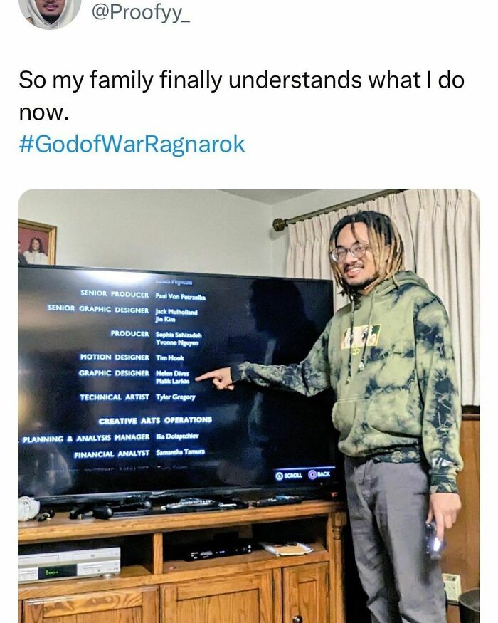 Young adult proudly points to video game credits on TV, illustrating the best and worst student life moments.