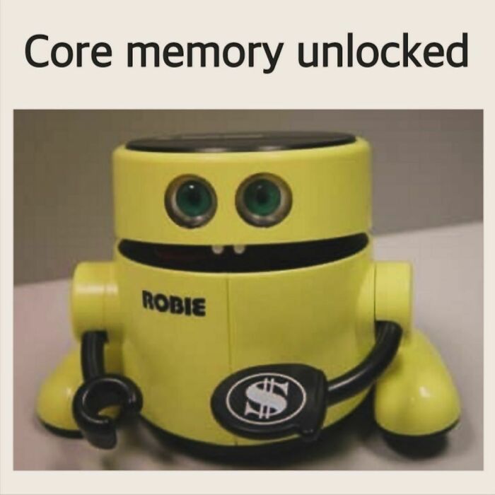 Yellow vintage robot toy named Robie with green eyes and dollar sign symbol, evoking nostalgic memories unlocked.