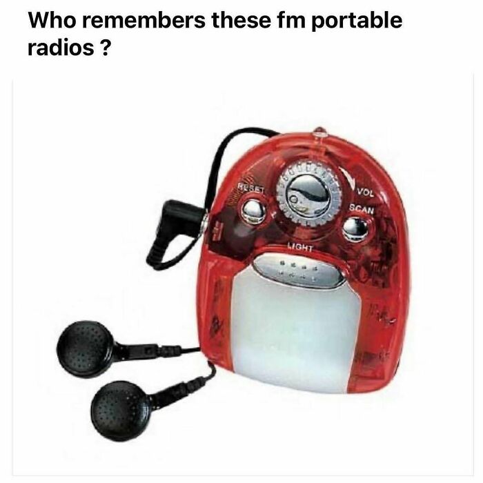 Red translucent vintage FM portable radio with attached black earbuds, nostalgic item triggering childhood memories and retro technology.