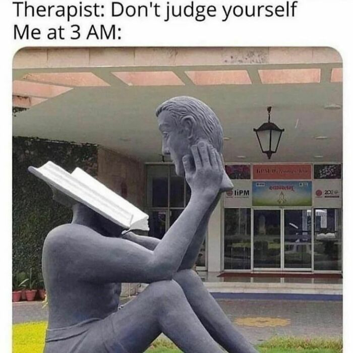 Statue with a book as a head, holding a face, captioned about self-judgment, relatable meme.