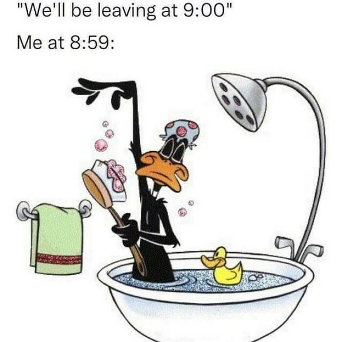 Daffy Duck in a bathtub washing at 8:59 with a brush and rubber duck, illustrating relatable random meme humor.