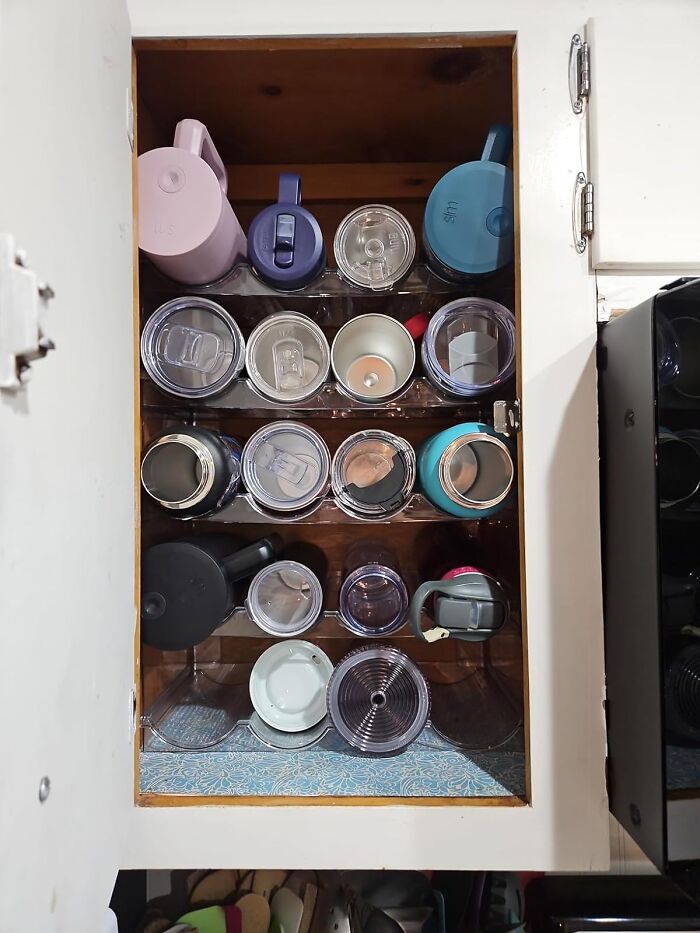 Organized pantry with reusable containers neatly stacked on shelves.