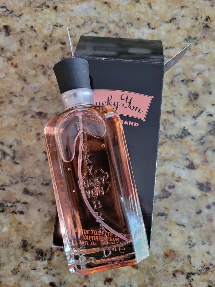 Affordable Mother’s Day gift idea: a bottle of Lucky You perfume against a granite background.