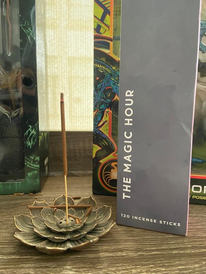 Incense sticks in a floral holder beside a box labeled "The Magic Hour," perfect for a cheerful Mother’s Day gift.
