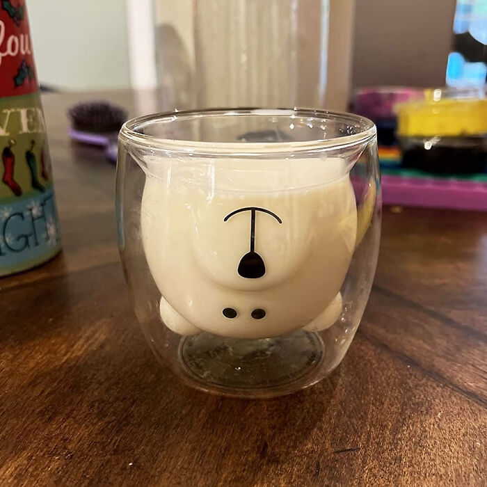 Cute bear-shaped glass, an unusual kitchen item, resting on a wooden table.