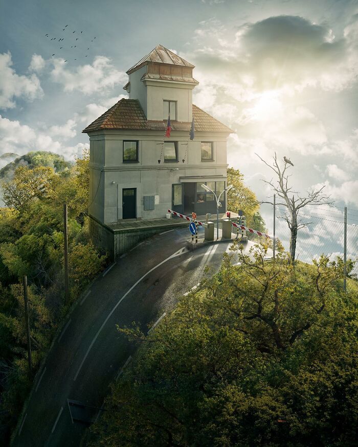 Building atop a steep, curving road with surreal, elevated perspective, showcasing mind-bending photo manipulation.