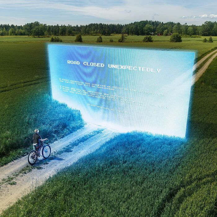 Cyclist encounters a giant digital error message blocking a rural path, showcasing mind-bending photo manipulation.