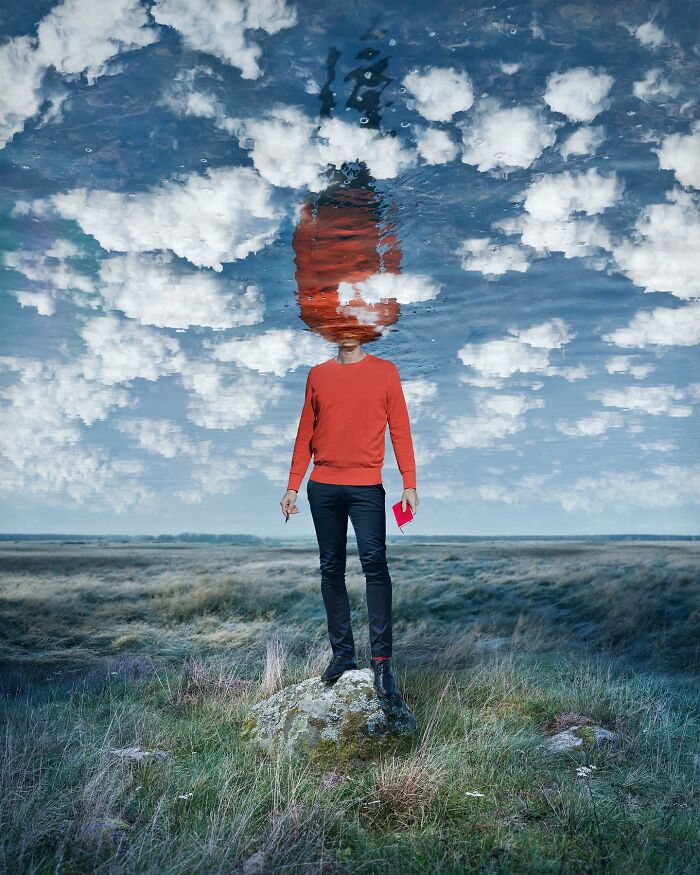 Surreal photo manipulation by Swedish Photoshop master Erik Johansson, featuring a man in a red sweater with a sky reflection.
