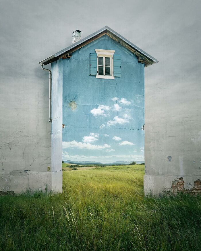 Wall with a painted landscape creating an optical illusion by Swedish photo manipulation artist Erik Johansson.