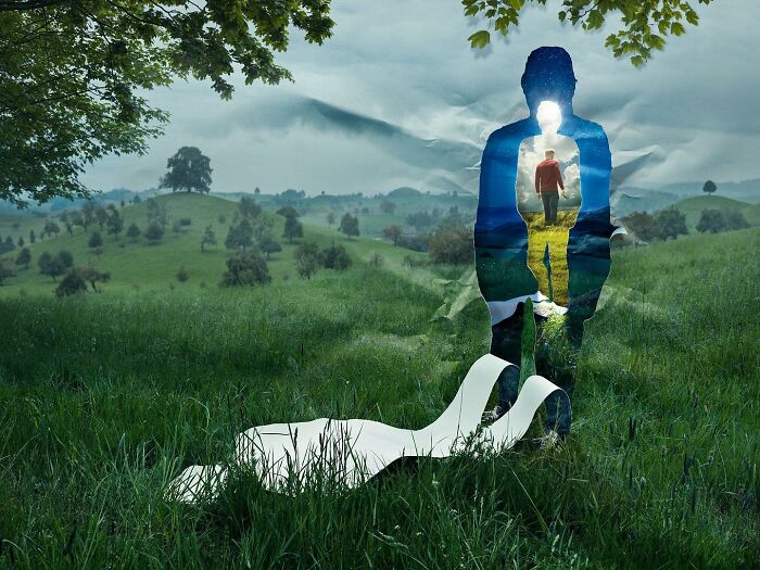 Silhouette of a man blending with a hilly landscape; a surreal photo manipulation by a Photoshop master.