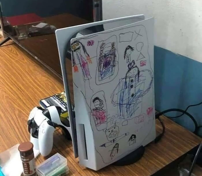 Gaming console covered with colorful children's drawings, reflecting a messy day for parents dealing with creativity and chaos.