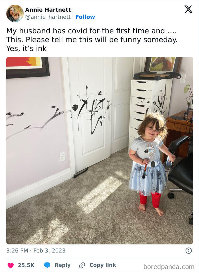 Toddler with ink-stained hands and dress, standing in a room with walls and doors covered in black ink marks, parents having a miserable day.