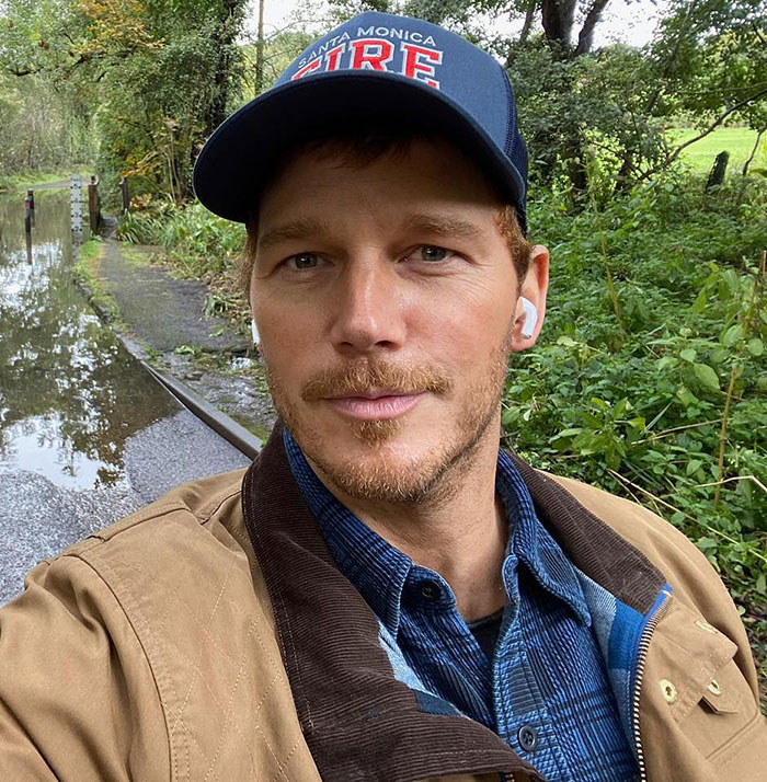 Chris Pratt outdoors wearing a cap and jacket, sparking controversy with a Mother's Day post.