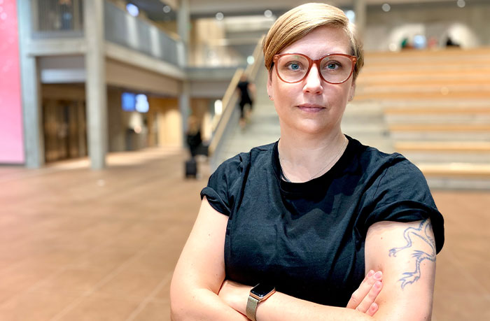 Person with tattoo in an indoor setting, arms crossed. Person with tattoo in an indoor setting, arms crossed.