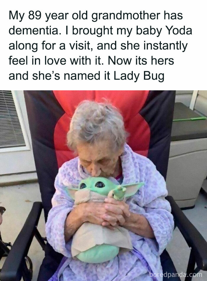 Elderly woman affectionately holding a Baby Yoda plush, embodying Disney adult meme humor.
