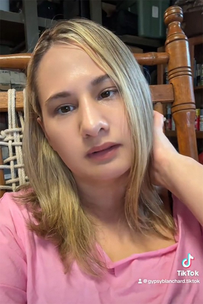 Gypsy Rose Blanchard in a pink top, sitting indoors, sharing a video message.