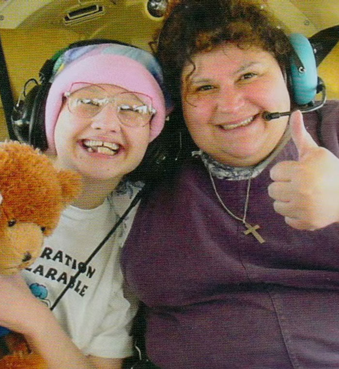 Smiling individuals with headsets, one holding a teddy bear, illustrating Gypsy Rose Blanchard looking past abuse.