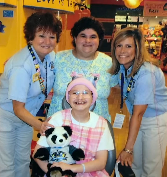 Smiling group in a cheerful setting, with a young person holding a panda toy, conveying warmth and togetherness.