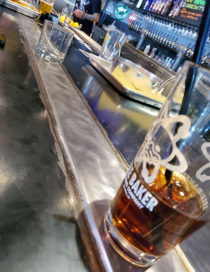 The Bar I'm Sitting At Has A Cold Metal Bar To Keep Your Drinks Cold