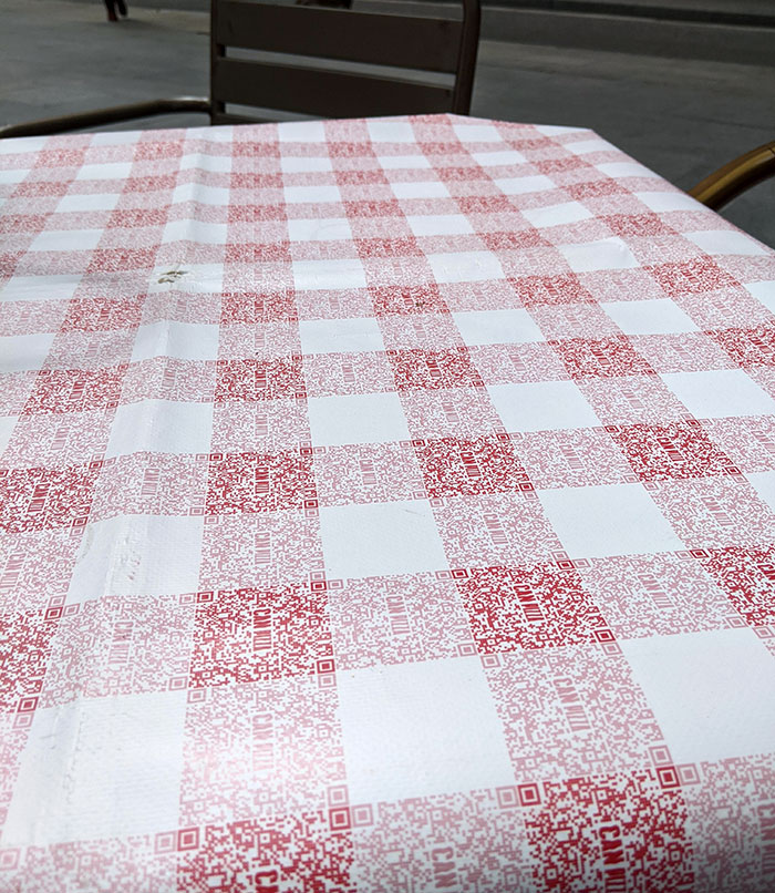 The Classic Red Checkered Pattern Of The Tablecloth Of This Restaurant Is Made Of QR Codes For Their Menu