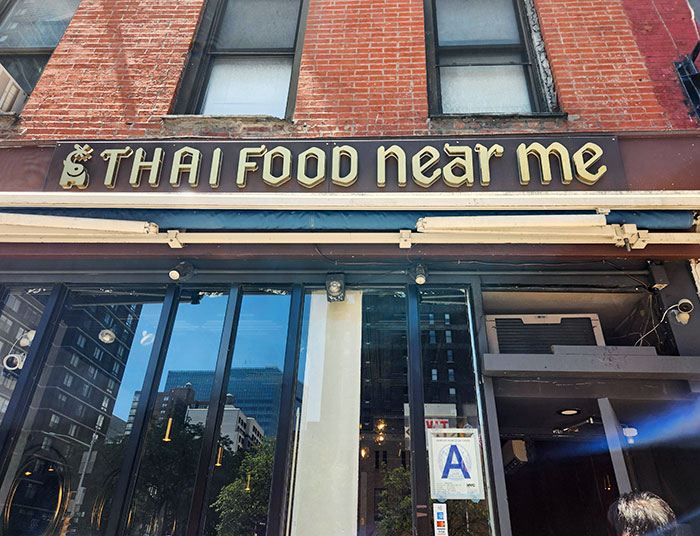 Exterior view of a bar and restaurant with a sign reading Thai food near me, showcasing innovative dining ideas.