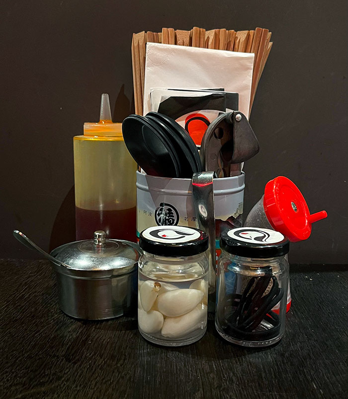 This Ramen Restaurant Has Hair Ties, Garlic Cloves, And A Garlic Press At Each Table