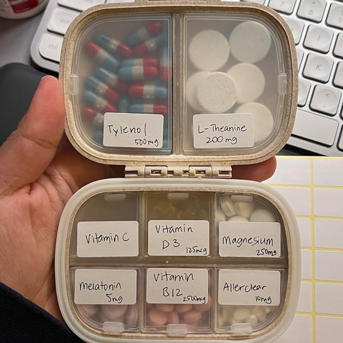 Pill organizer with various supplements and medications for travel, perfect for a light and smart vacation packing strategy.