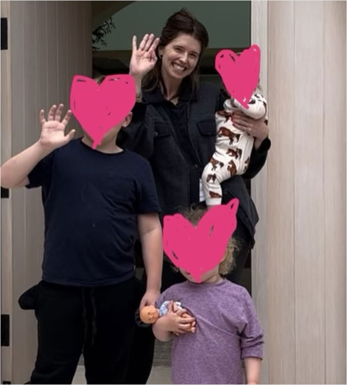 Woman smiling with three kids, including a baby, waving on Mother's Day.