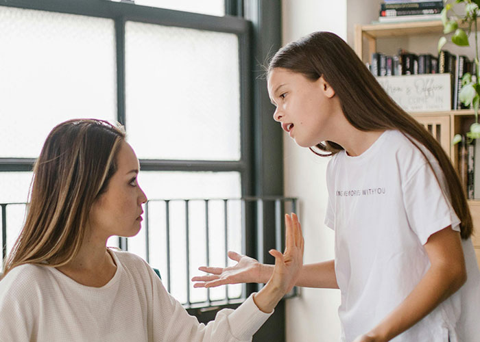 Woman and girl in an intense conversation, representing a cringe-worthy experience.