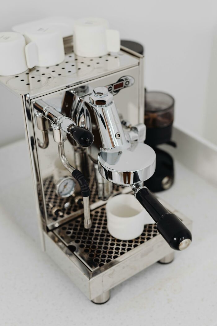Compact stainless steel espresso machine on kitchen counter, ideal for saving money with frugal wins and smart purchases.