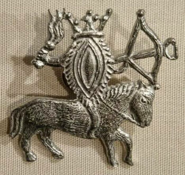 Viva La Vulva Amulet: Crowned, Mounted On A Horse, Wielding A Crossbow And A Torch, In Silver. Medieval European Pilgrims Wore These Apotropaic Medals To Protect Against Plague, Robbers, Rapists, And Other Dangers