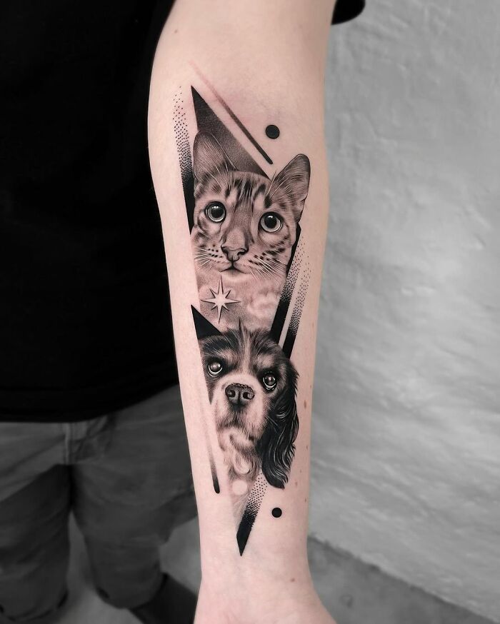Forearm with a cute pet portrait tattoo featuring a cat and a dog in black and white design.
