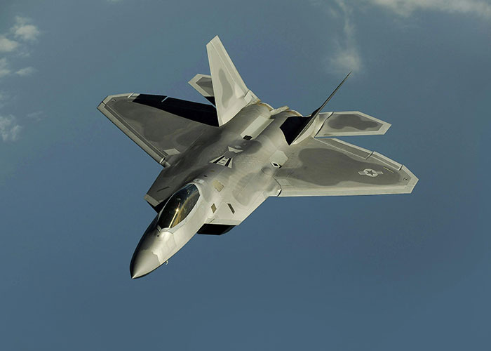 Stealth fighter jet flying against a clear sky, illustrating improbable events people experienced in aviation.