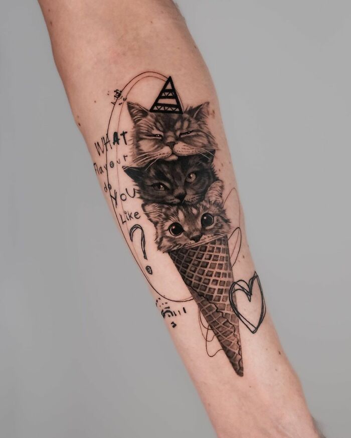 Cute pet portrait tattoo of three cats stacked in an ice cream cone design on a forearm.