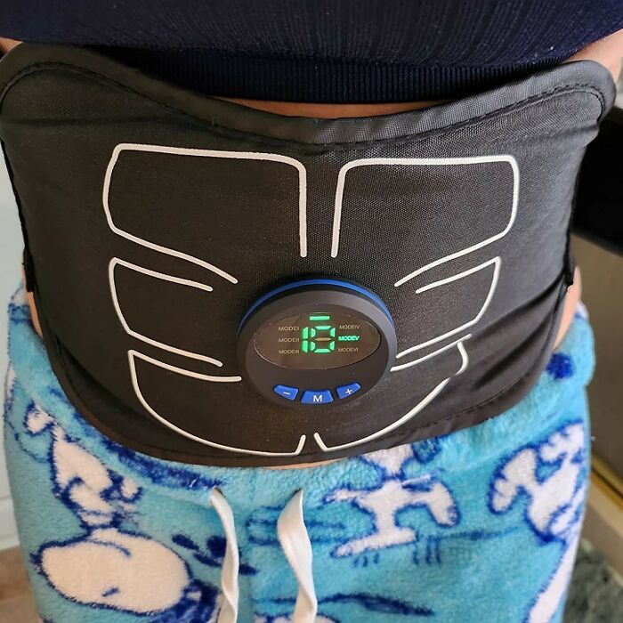 Black wearable device with digital display on waist, part of novelty finds for a dopamine hit and brain stimulation.