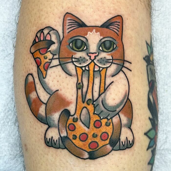 Cute pet portrait tattoo of a cat eating pizza on leg.