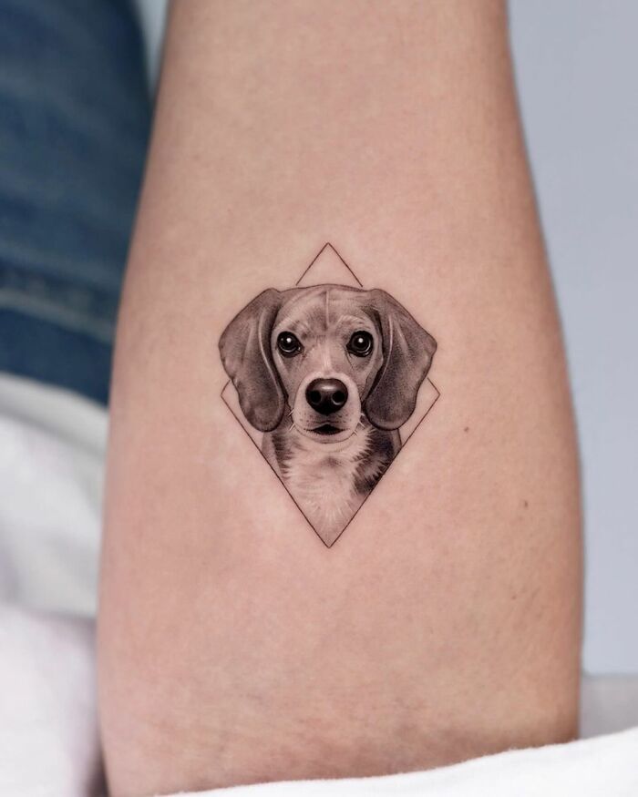 Beagle portrait tattoo by artist, featuring a realistic depiction on the skin, showcasing a cute pet design.