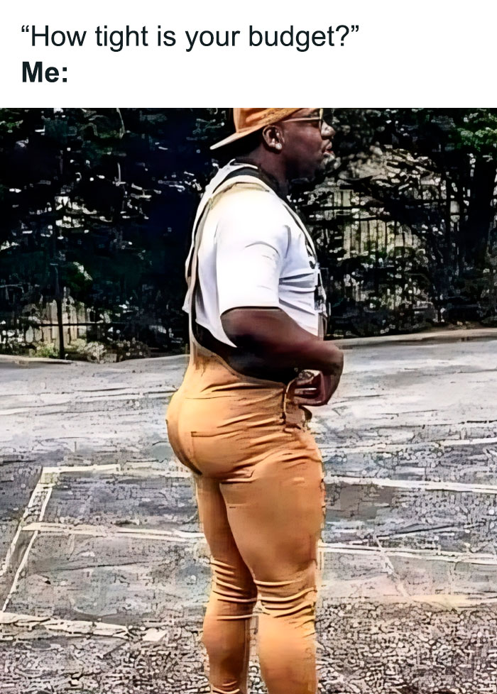 A man humorously wears tight pants to illustrate a joke about budget constraints.
