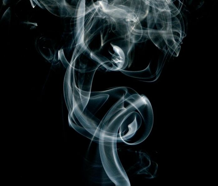 Abstract swirling smoke patterns on a black background illustrating reflections from people in their 40s, 50s, and 60s about Gen Z.