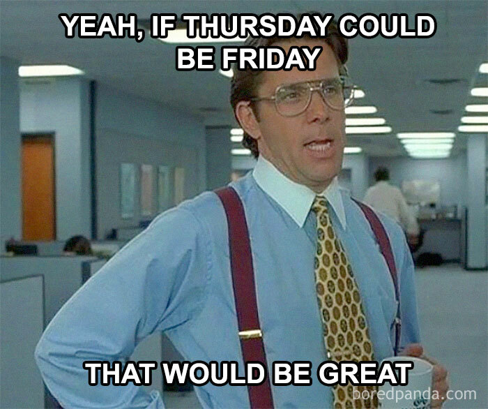 Office worker in glasses, blue shirt, and tie expressing humor about Thursday memes wishing it was Friday in a busy office.