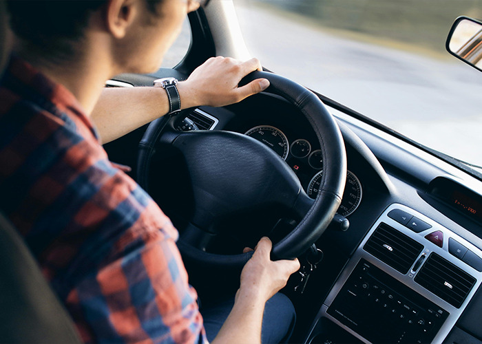Man driving a car focusing on the road, illustrating everyday things most people don’t realize are deadly risks.